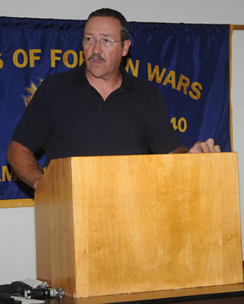 A man standing at the top of a podium.