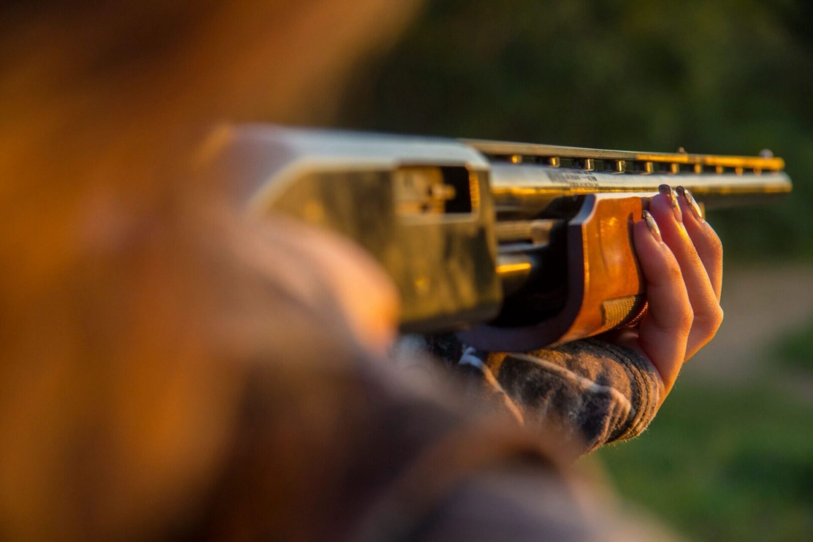 A person holding a gun in their hand.