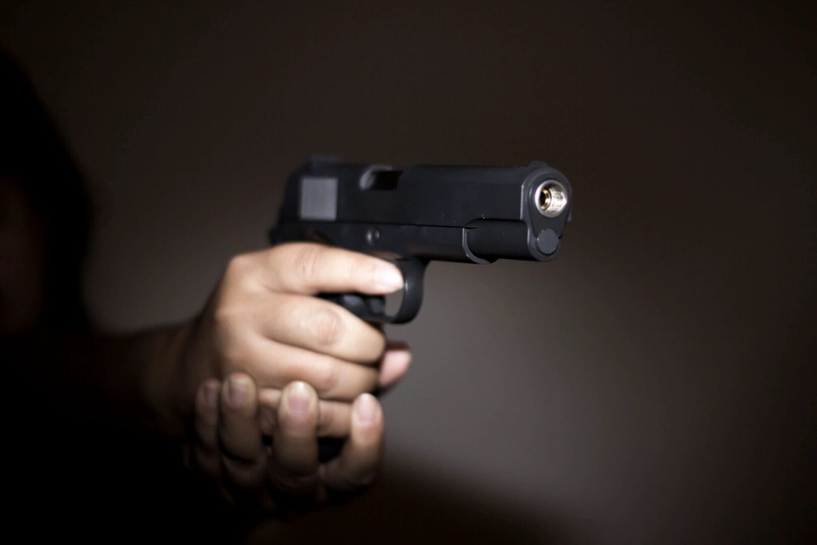 A person holding a gun in their hand.